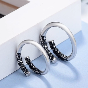 Detail of vintage 925 sterling silver Monkey King couple rings with engraved cloud patterns