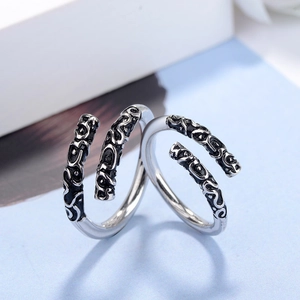 Macro shot of retro sterling silver ring featuring intricate engraved auspicious cloud patterns