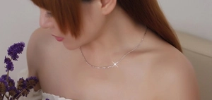 Detail of s925 sterling silver water wave chain necklace on a model's neck