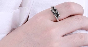 Detailed view of vintage silver ring with intricate Sun Wukong golden hoop patterns