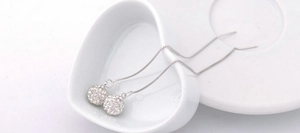 Macro shot of S925 silver threader earrings featuring sparkling crystal paved disco balls