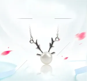 Macro shot of S925 sterling silver reindeer antler necklace with a freshwater pearl pendant