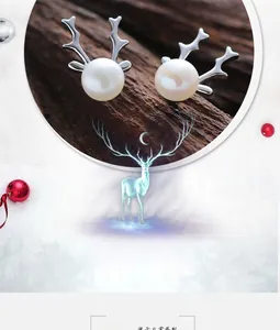 Macro detail of S925 sterling silver reindeer antler stud earrings with white pearls