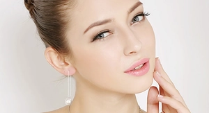 Close-up of elegant S925 silver threader earrings with dangling white round pearls