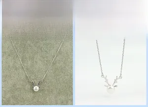 Detail of S925 silver reindeer antler necklace featuring a white freshwater pearl pendant