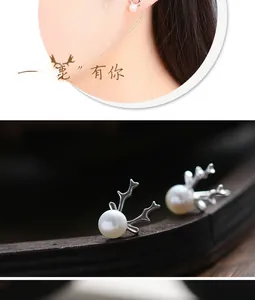 Macro detail of S925 silver reindeer antler stud earrings with white pearls