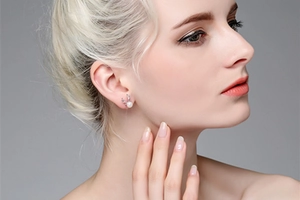 Close-up of S925 silver reindeer antler stud earrings with white pearl on model ear