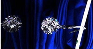 Close-up of sparkling cubic zirconia earrings with 925 sterling silver hooks on fabric