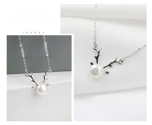 Detail of S925 silver reindeer antler necklace featuring a white freshwater pearl pendant