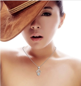 Close-up of a 925 silver crown pendant necklace with purple zircon on a fashion model