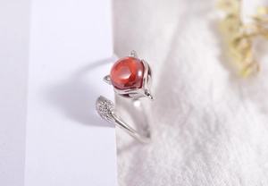 Detailed view of red agate fox ring with zircon tail on silver adjustable band