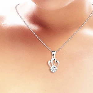 Elegant 925 sterling silver crown pendant necklace with round zircon on a model
