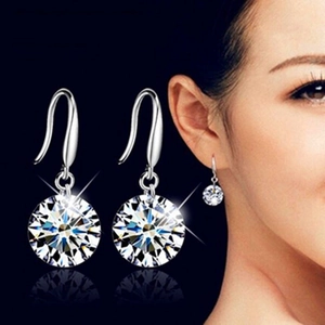925 Sterling Silver hook earrings with faceted clear zircon on model and dark background