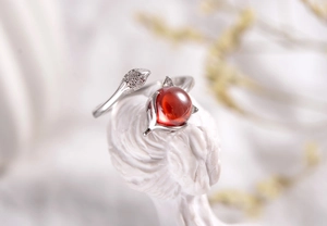 Macro detail of S925 silver fox ring with red gemstone and micro-set cubic zirconia