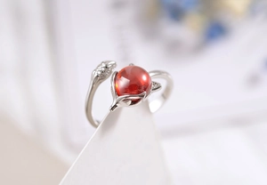 Macro shot of silver fox ring with red crystal bead and fine engraved details