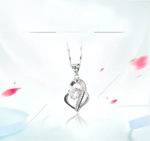 Detail of 925 sterling silver heart necklace with large sparkling round-cut gemstone