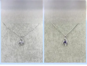 Detail of S925 silver heart pendants with purple and clear zircon stone options