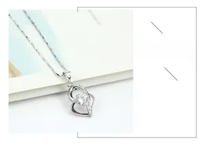 Macro detail of S925 sterling silver heart necklace featuring a sparkling round center stone