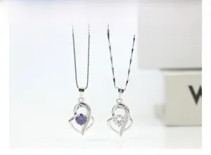 Detail of 925 sterling silver heart necklaces with purple and white cubic zirconia stones
