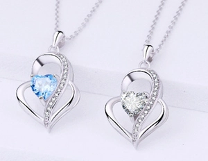 Macro shot of 925 sterling silver heart pendants with blue and white stones
