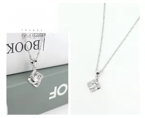 Macro detail of S925 sterling silver four-leaf clover necklace with sparkling cubic zirconia