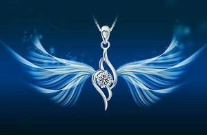 Detail of s925 silver wing pendant with heart engraving and round cut zirconia stone