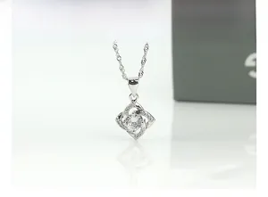 Macro shot of S925 sterling silver four-leaf clover pendant with sparkling cubic zirconia