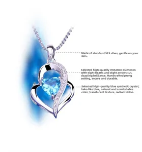 Macro detail of 925 sterling silver heart necklace with blue crystal and hand-set stones