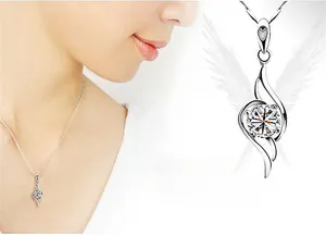 Detail of s925 silver angel wing pendant necklace with sparkling center stone on neck