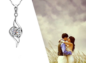 Macro view of S925 sterling silver angel wing pendant with heart and round diamond zircon