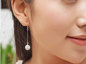 Detail of s925 silver drop earrings featuring long box chains and sparkling crystal balls