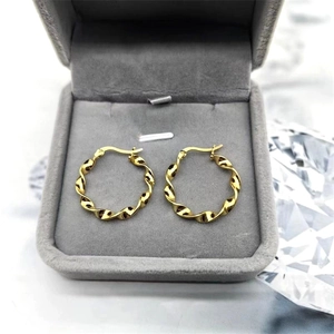 Elegant 18K gold-plated twisted hoop earrings displayed in a luxury grey velvet jewelry box