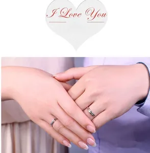 Close-up of S925 sterling silver couple rings with zircon inlays and I Love You engraving