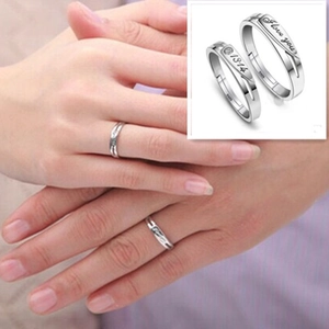 Macro detail of S925 sterling silver couple rings showing I love you and 1314 engravings