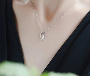 Close-up of S925 sterling silver moon cat necklace worn on a female model