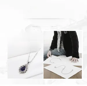 Detailed view of pear-shaped amethyst pendant with halo cubic zirconia setting in silver