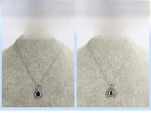 Macro detail of pear-shaped blue gemstone pendant necklace with white zircon halo on silver chain