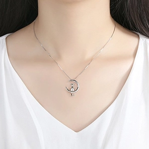 S925 sterling silver necklace featuring a cat on a moon pendant worn by a model