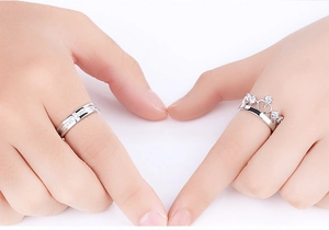 Close-up of S925 sterling silver crown rings set for couples with white zircon stones