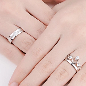 Detail of s925 silver couple rings featuring a crown heart design and pave set zircon stones