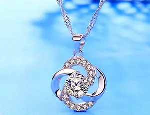 Macro view of S925 sterling silver four-leaf clover pendant with sparkling zircon accents