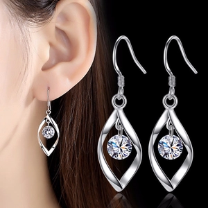 S925 sterling silver twist drop earrings with round clear zircon shown on a model