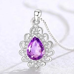 Macro view of pear-shaped purple amethyst pendant with retro silver镂空 detail