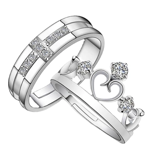 Elegant S925 sterling silver crown couple rings with micro-set diamonds on white background