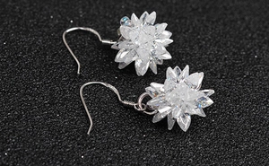 Macro shot of 925 sterling silver flower earrings with ice-cut zircon stones