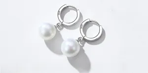 Detailed view of S925 sterling silver stamp and white shell pearls on elegant earrings