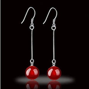 Elegant S925 sterling silver long tassel earrings with red agate beads on black background