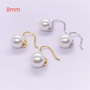 Close-up of 8mm shell pearl earrings with S925 sterling silver hallmark engraving