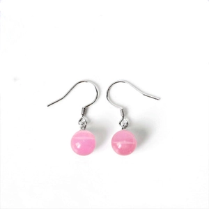 Detailed macro view of pink cat eye stone drop earrings with silver hooks for women