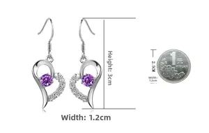 Detailed view of heart-shaped silver earrings with purple zircon and size reference